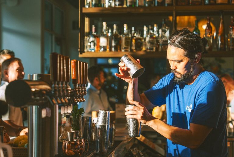 Barista working during sunset hour at The Surfing Fox